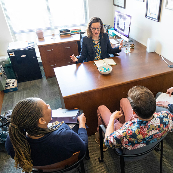 Dr. Jennifer Ayres meeting with students in her office