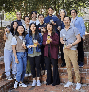students and faculty stand outside holding cups of bubble tea