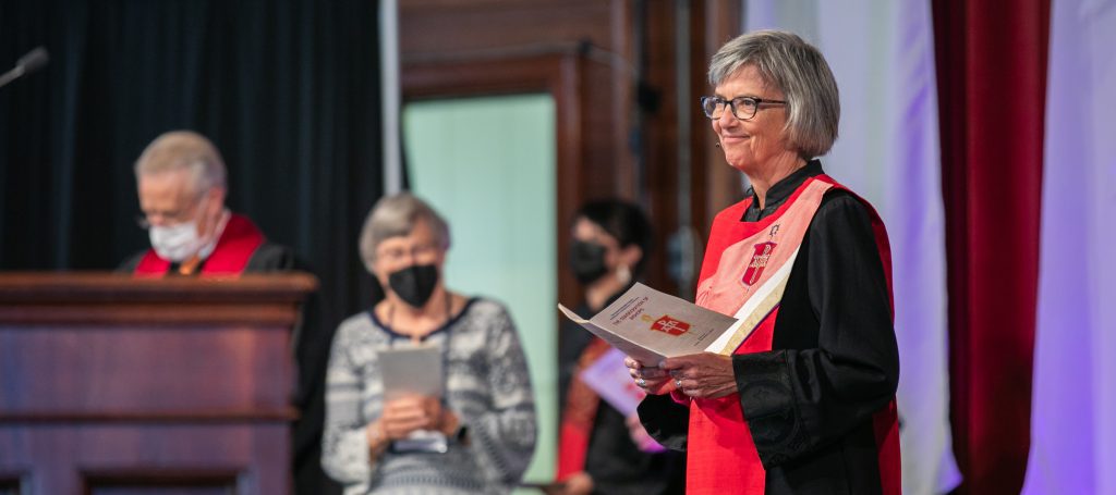 Bishop Hope Morgan Ward stands at the front of a worship service