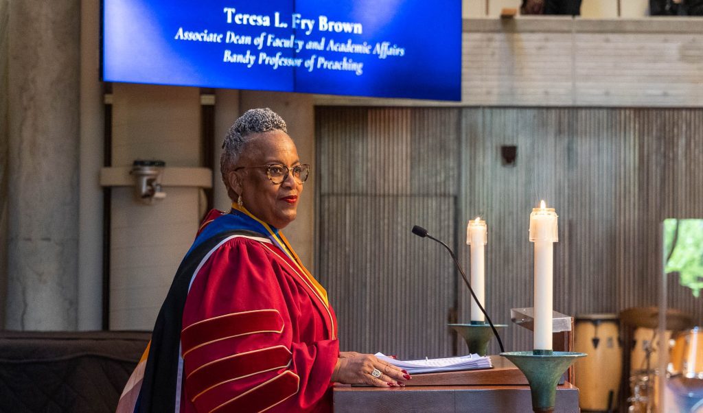 Teresa Fry Brown stands at Cannon Chapel lectern in academic regalia