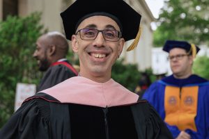 David Daniel smiles in academic regalia