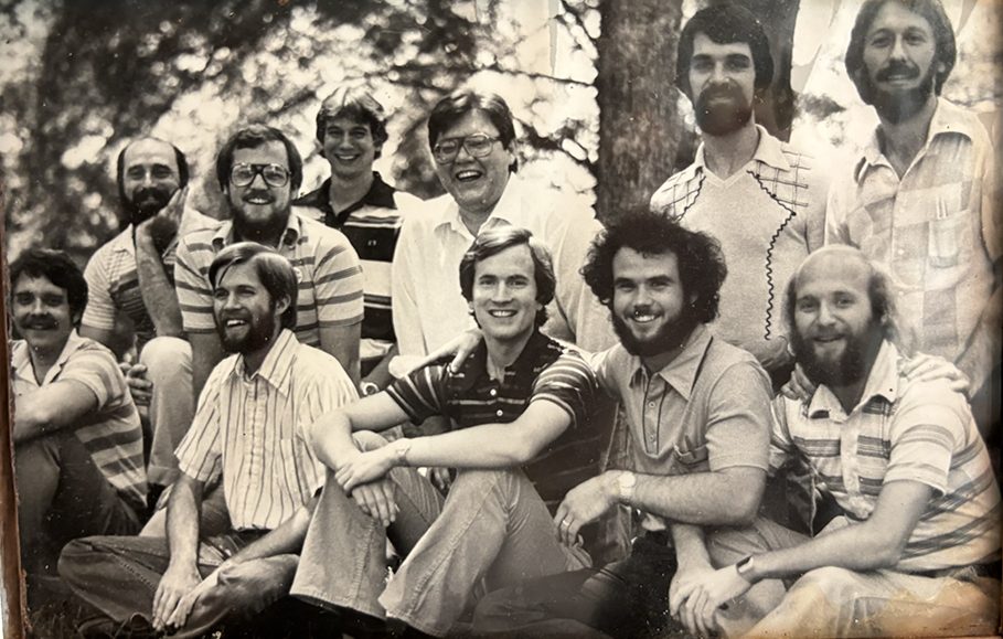 black and white photo in a frame of a group of young men smiling