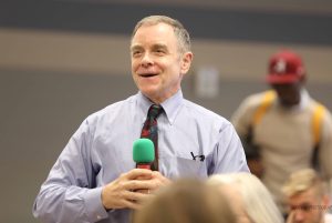 Ed Phillips speaks into a hand held microphone